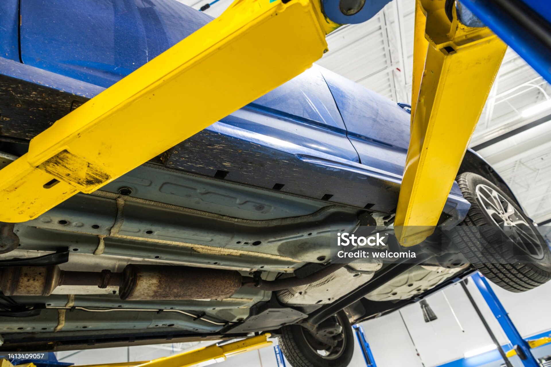Closeup of a Blue Car Being Lifted at the Auto Service Center