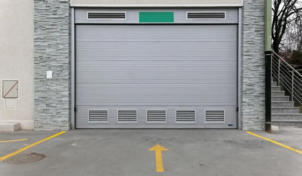 Heavy-duty commercial garage doors with ventilation grilles.