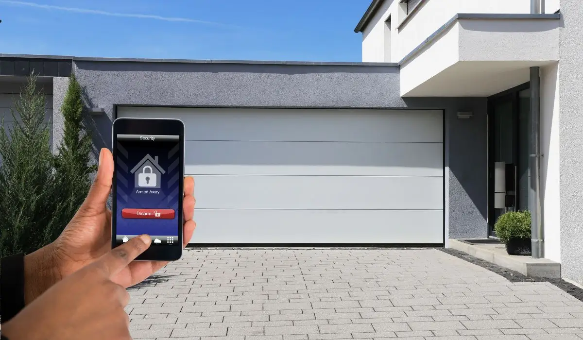 Person using smartphone app to remotely control smart garage door for secure and convenient home access management.