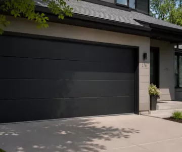 Garage Door Design Trends featuring modern black flush-panel garage door on contemporary suburban home exterior