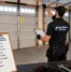 Garage door technician performing spring garage door maintenance checklist in Woodridge inspecting tracks, springs, and components safely.